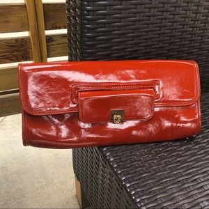 Orange patent leather clutch purse.  H&M